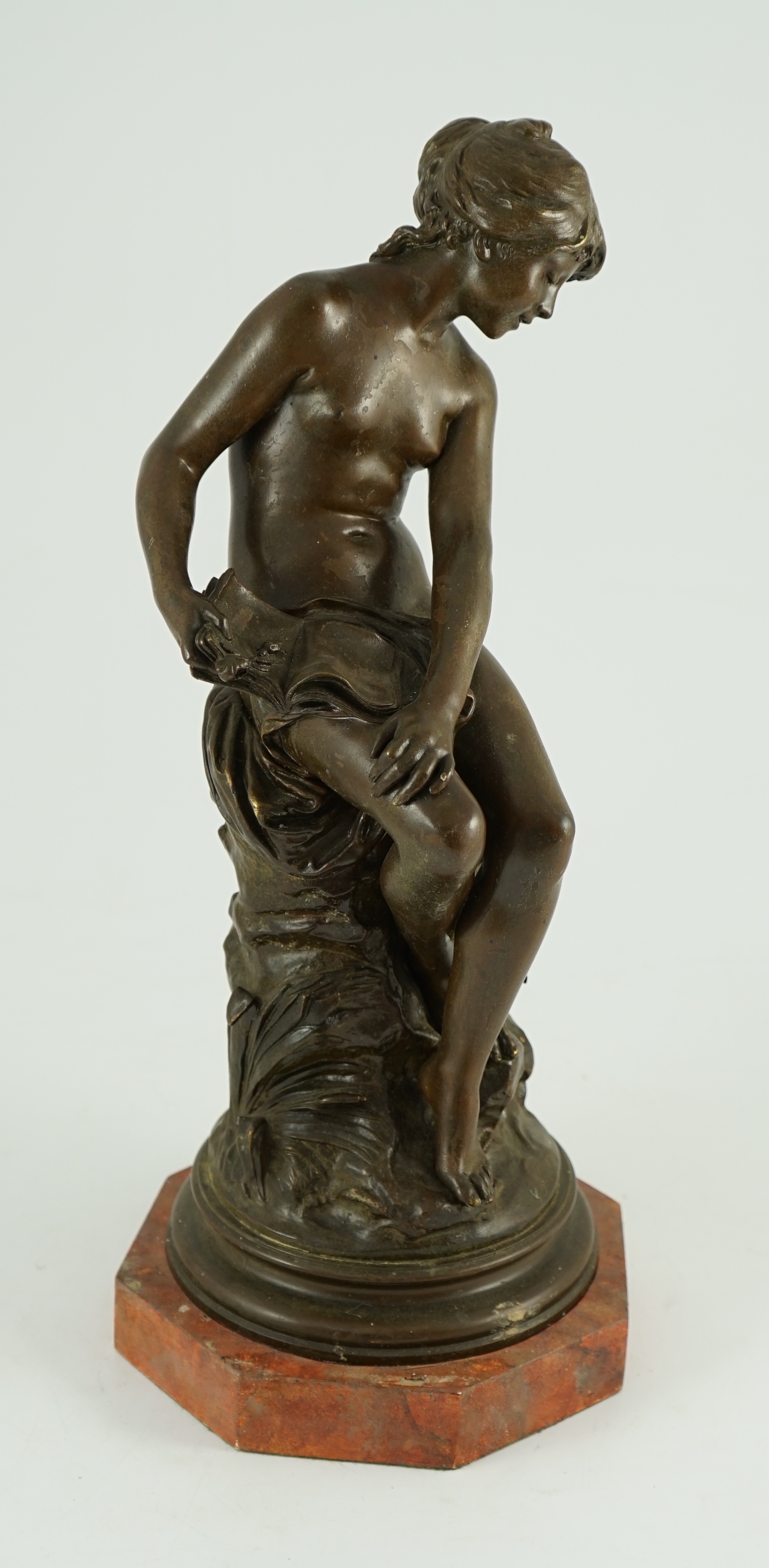 Auguste Moreau (French, 1834-1917). A bronze figure of a nude girl seated on a mound holding a book with birds at her feet, overall height 45cm
